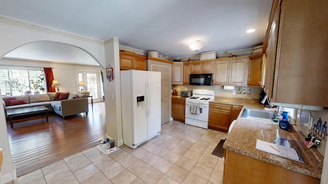 34 Sandy Acres Dr, Sullivan, ME 04664 - kitchen featuring white appliances, arched walkways, open floor plan, and light tile patterned floors