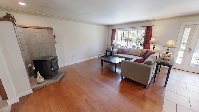 34 Sandy Acres Dr, Sullivan, ME 04664 - living area featuring plenty of natural light, a wood stove, a baseboard radiator, light wood finished floors, and recessed lighting