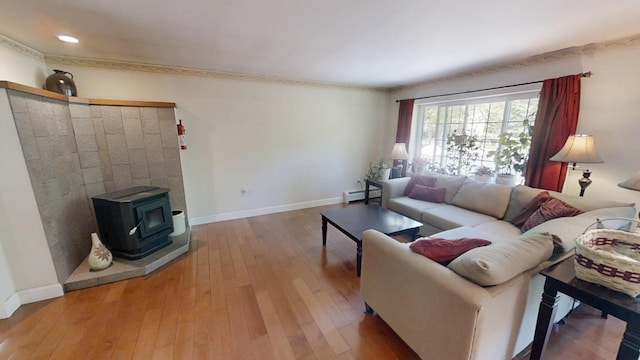 34 Sandy Acres Dr, Sullivan, ME 04664 - living room with a baseboard radiator, a wood stove, hardwood / wood-style flooring, and recessed lighting
