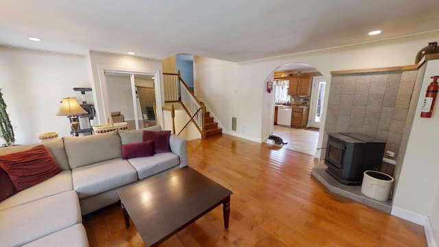 34 Sandy Acres Dr, Sullivan, ME 04664 - living area with arched walkways, light wood finished floors, stairway, a wood stove, and recessed lighting
