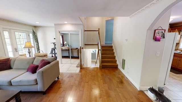 34 Sandy Acres Dr, Sullivan, ME 04664 - living room featuring arched walkways, stairway, light wood-type flooring, and recessed lighting