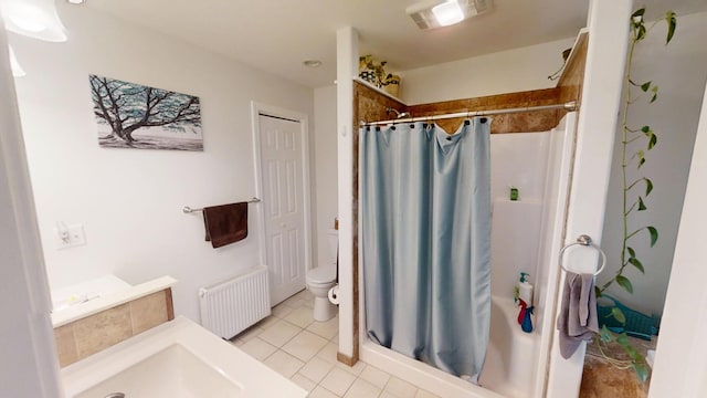 34 Sandy Acres Dr, Sullivan, ME 04664 - bathroom with radiator, a stall shower, and tile patterned floors