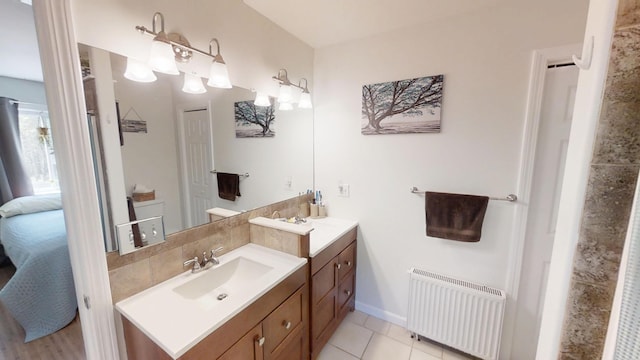 34 Sandy Acres Dr, Sullivan, ME 04664 - ensuite bathroom with radiator, two vanities, and tile patterned flooring