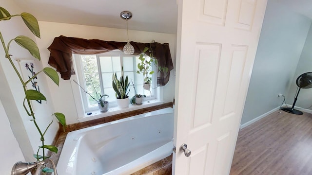 34 Sandy Acres Dr, Sullivan, ME 04664 - bathroom with a whirlpool tub and wood finished floors