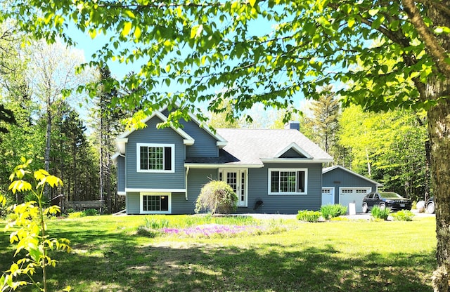 34 Sandy Acres Dr, Sullivan, ME 04664 - tri-level home with a chimney, a front yard, and a garage