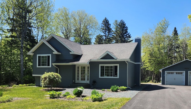 34 Sandy Acres Dr, Sullivan, ME 04664 - tri-level home featuring a chimney, a garage, an outbuilding, and a front yard