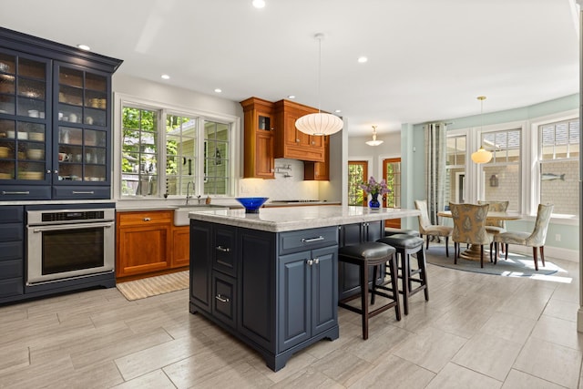 38 Darcy Rd, York, ME 03909 - kitchen featuring stainless steel oven, a sink, plenty of natural light, a kitchen bar, and recessed lighting
