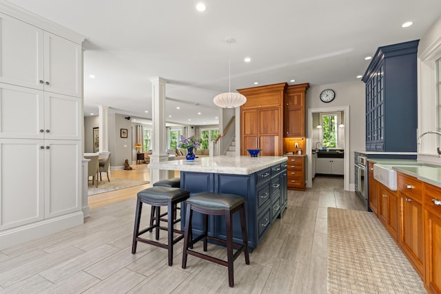 38 Darcy Rd, York, ME 03909 - kitchen with a sink, ornate columns, a kitchen island, recessed lighting, and a kitchen bar