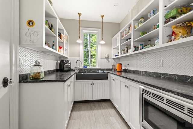38 Darcy Rd, York, ME 03909 - kitchen with open shelves, stainless steel microwave, backsplash, a sink, and dark countertops