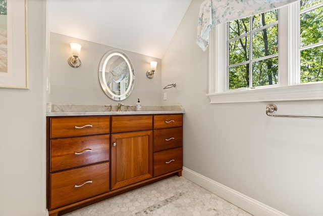 38 Darcy Rd, York, ME 03909 - bathroom featuring plenty of natural light, vanity, vaulted ceiling, baseboards, and tile patterned flooring