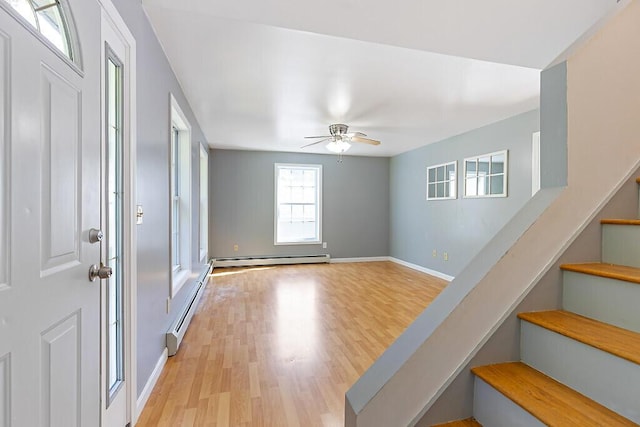 40 Guptill Rd, Belgrade, ME 04917 - foyer entrance with a baseboard heating unit, wood finished floors, stairway, and a ceiling fan