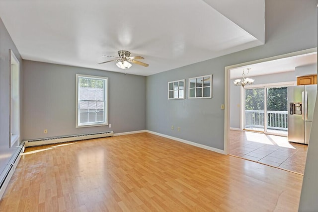 40 Guptill Rd, Belgrade, ME 04917 - empty room featuring a baseboard radiator, a ceiling fan, a chandelier, and light wood-style flooring