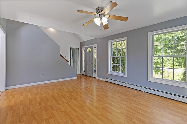 40 Guptill Rd, Belgrade, ME 04917 - unfurnished living room featuring a baseboard heating unit, light wood finished floors, a ceiling fan, vaulted ceiling, and stairs