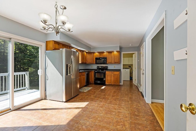 40 Guptill Rd, Belgrade, ME 04917 - kitchen with black appliances, brown cabinets, dark countertops, a chandelier, and pendant lighting