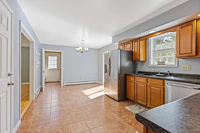 40 Guptill Rd, Belgrade, ME 04917 - kitchen featuring appliances with stainless steel finishes, a baseboard heating unit, a chandelier, and dark countertops