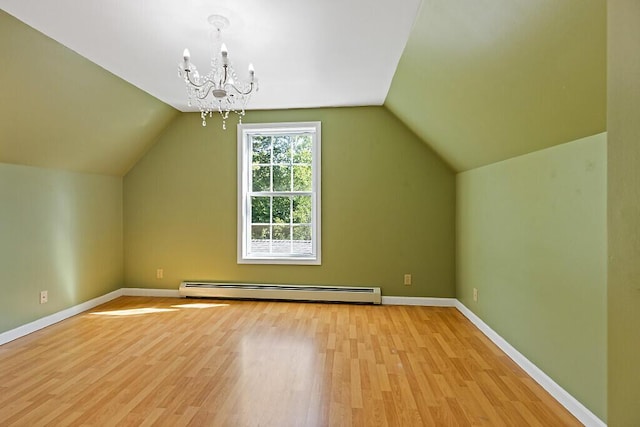 40 Guptill Rd, Belgrade, ME 04917 - additional living space with a baseboard heating unit, light wood-style flooring, a chandelier, and lofted ceiling