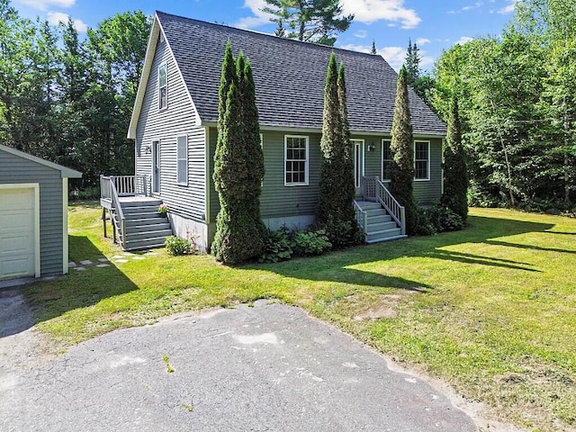 40 Guptill Rd, Belgrade, ME 04917 - new england style home with a front lawn, a shingled roof, and an outdoor structure