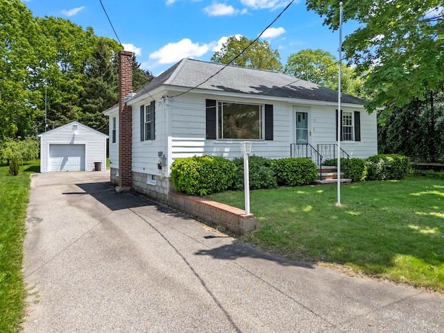 12 Neally St, South Berwick, ME 03908 - view of front facade with an outdoor structure, a chimney, a detached garage, a shingled roof, and a front lawn