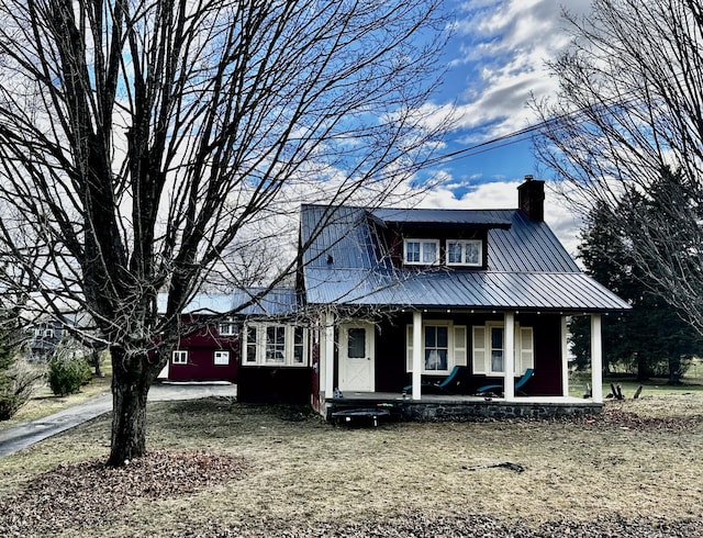 33 Washington St, Caribou, ME 04736 - view of front of house with a porch, a chimney, and metal roof