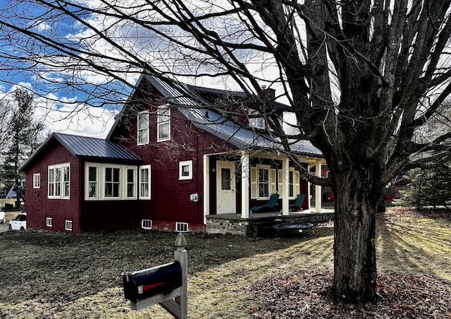 33 Washington St, Caribou, ME 04736 - view of side of home with metal roof and a porch