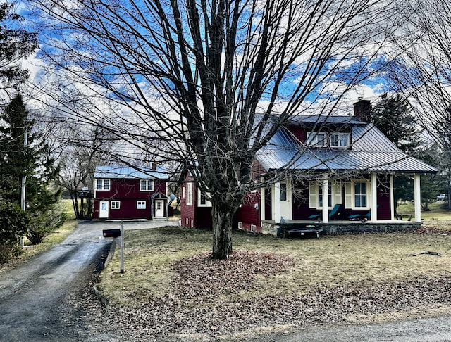 33 Washington St, Caribou, ME 04736 - view of front facade with covered porch, a chimney, and driveway