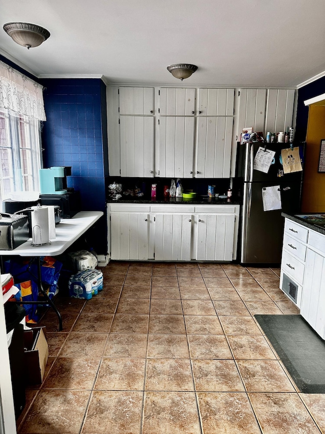 33 Washington St, Caribou, ME 04736 - kitchen featuring freestanding refrigerator, tile patterned flooring, white cabinetry, and dark countertops