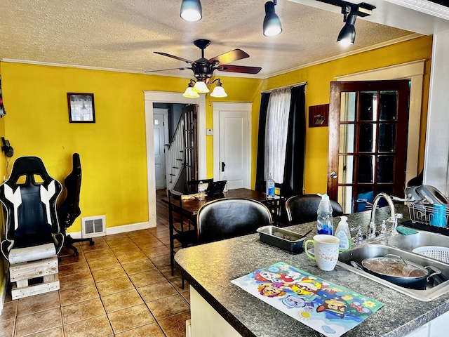 33 Washington St, Caribou, ME 04736 - dining room with a ceiling fan, ornamental molding, tile patterned floors, a textured ceiling, and stairs