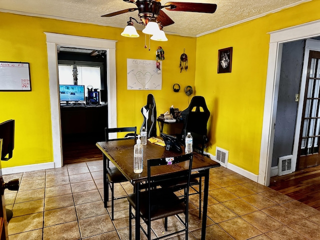 33 Washington St, Caribou, ME 04736 - dining area with a ceiling fan, a textured ceiling, baseboards, ornamental molding, and tile patterned flooring