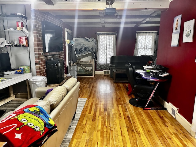 33 Washington St, Caribou, ME 04736 - living area with wood-type flooring and beam ceiling