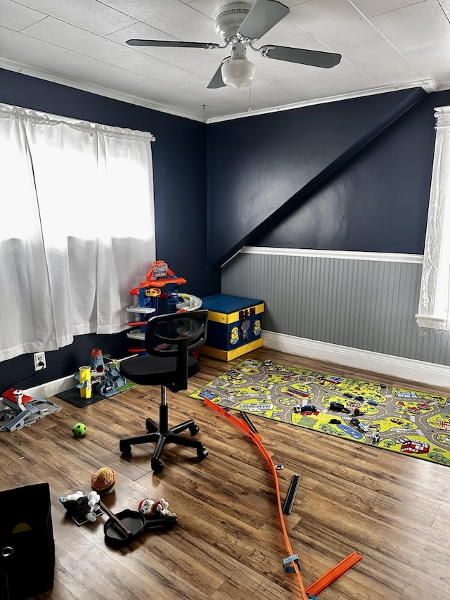 33 Washington St, Caribou, ME 04736 - rec room with a ceiling fan, wood finished floors, and wainscoting