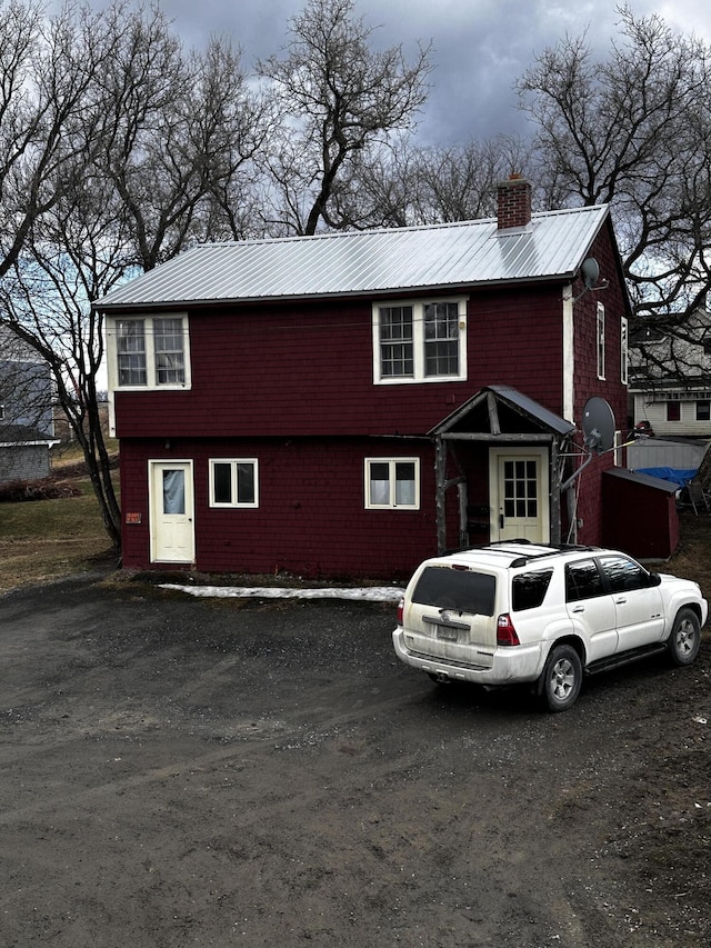 33 Washington St, Caribou, ME 04736 - view of front of house featuring metal roof and a chimney
