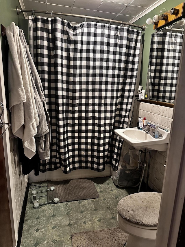 33 Washington St, Caribou, ME 04736 - bathroom featuring a sink, toilet, a shower with curtain, and tile walls