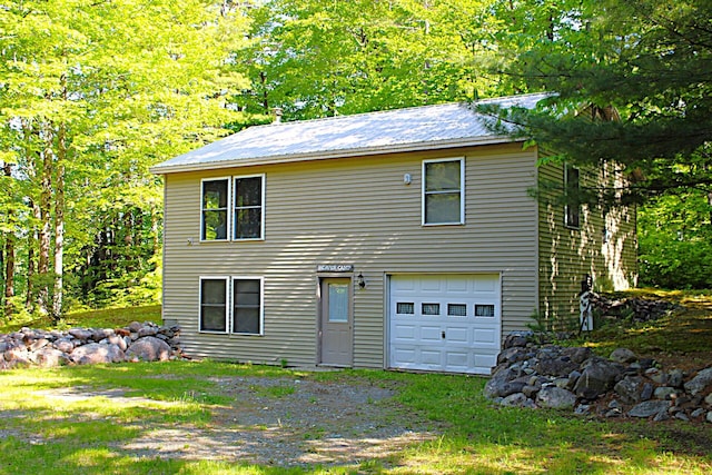 20 Blue Jay Dr, Embden, ME 04958 - view of front of property featuring a garage, metal roof, and driveway