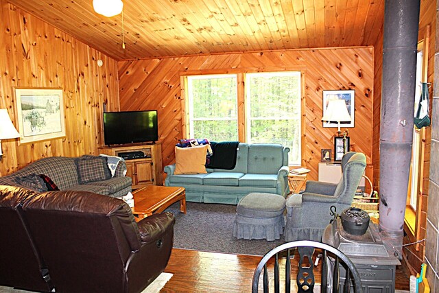 20 Blue Jay Dr, Embden, ME 04958 - living room with wood walls, a wood stove, wood finished floors, and wooden ceiling