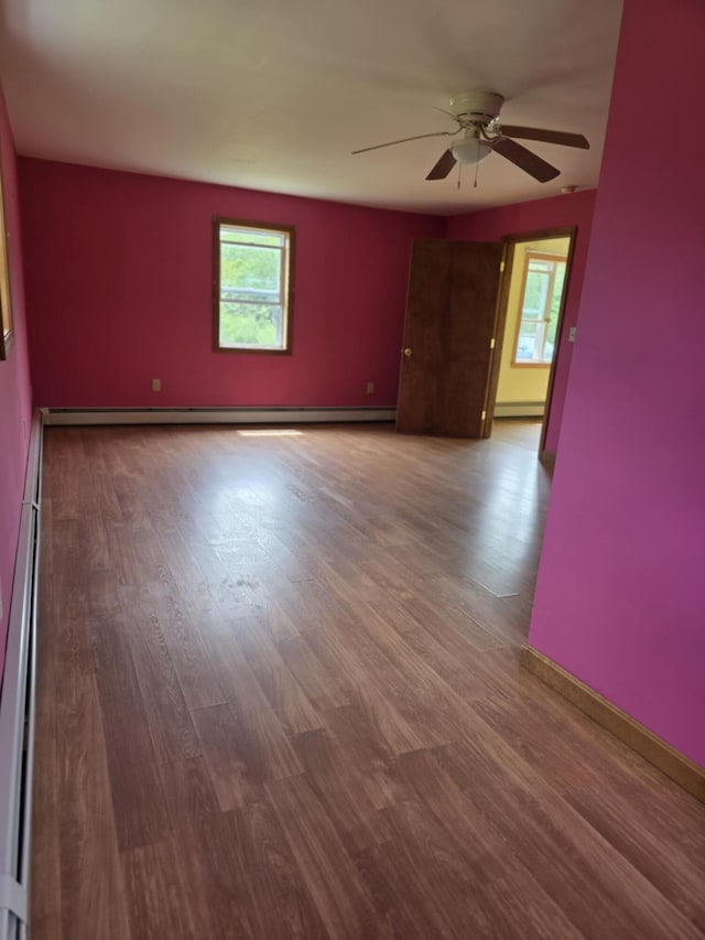 61 Gagnon Rd, Oakland, ME 04963 - spare room featuring plenty of natural light, ceiling fan, wood finished floors, and baseboard heating