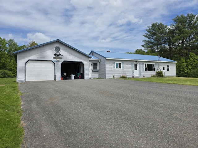 61 Gagnon Rd, Oakland, ME 04963 - ranch-style home with asphalt driveway, a garage, and a front yard