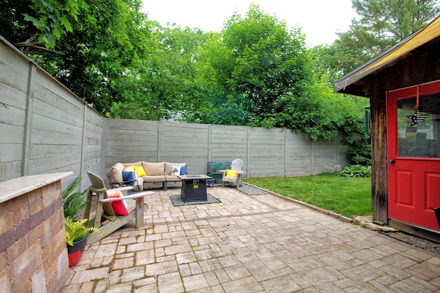 14 Jude Ln, Ellsworth, ME 04605 - fenced backyard featuring a patio and an outdoor living space with a fire pit