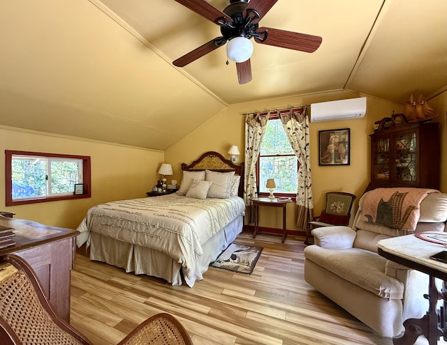 22 Old Mill Rd, Talmadge, ME 04492 - bedroom with vaulted ceiling, a wall mounted air conditioner, light wood finished floors, a ceiling fan, and baseboards