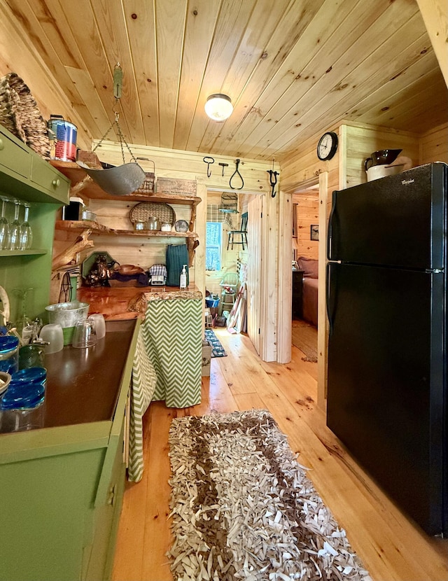 22 Old Mill Rd, Talmadge, ME 04492 - kitchen featuring freestanding refrigerator, green cabinetry, wooden ceiling, light wood finished floors, and wood walls