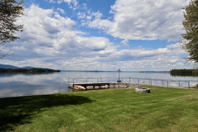 500 Black Point Rd, Beaver Cove, ME 04441 - dock with a water view, a lawn, and an outdoor fire pit