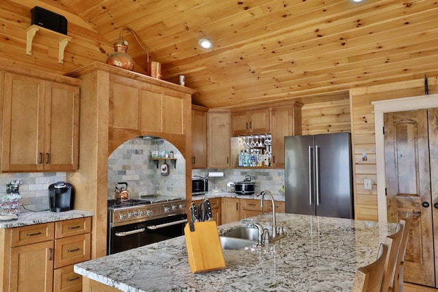 500 Black Point Rd, Beaver Cove, ME 04441 - kitchen with high quality appliances, lofted ceiling, wood ceiling, decorative backsplash, and a sink
