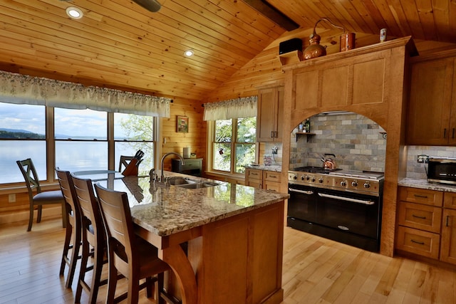 500 Black Point Rd, Beaver Cove, ME 04441 - kitchen featuring stainless steel appliances, a sink, lofted ceiling, wooden ceiling, and brown cabinets
