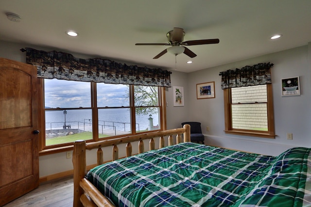 500 Black Point Rd, Beaver Cove, ME 04441 - bedroom featuring light wood-style flooring, a water view, recessed lighting, and ceiling fan