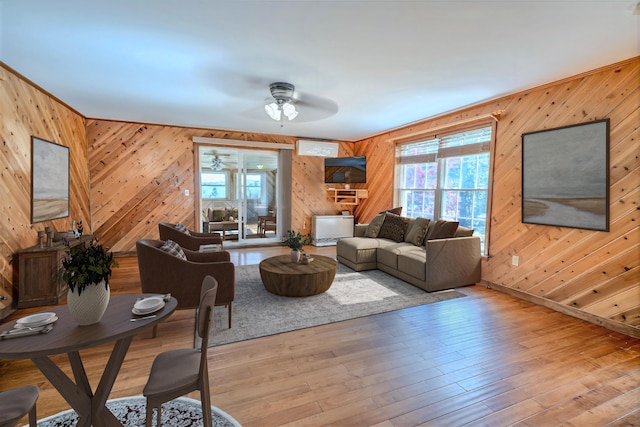 3 Reeds Ln, Belfast, ME 04915 - living room with wood walls, ceiling fan, healthy amount of natural light, and wood-type flooring