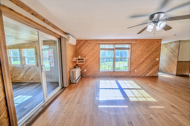 3 Reeds Ln, Belfast, ME 04915 - unfurnished living room with wood walls, heating unit, ceiling fan, and light wood-style flooring