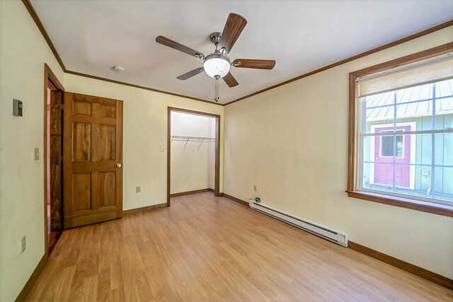 3 Reeds Ln, Belfast, ME 04915 - unfurnished bedroom featuring baseboard heating, crown molding, light wood-style flooring, a closet, and baseboards