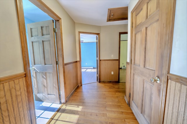 3 Reeds Ln, Belfast, ME 04915 - hall with wainscoting, light wood finished floors, a baseboard radiator, and wood walls