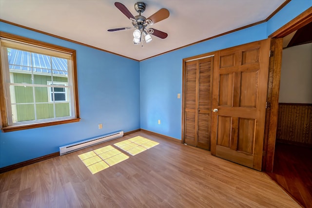 3 Reeds Ln, Belfast, ME 04915 - unfurnished bedroom featuring baseboard heating, wood finished floors, a closet, ornamental molding, and baseboards