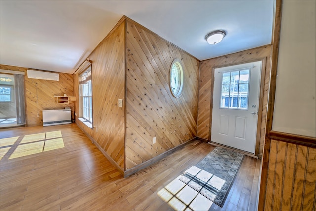 3 Reeds Ln, Belfast, ME 04915 - foyer featuring an AC wall unit, wooden walls, and light wood-style flooring