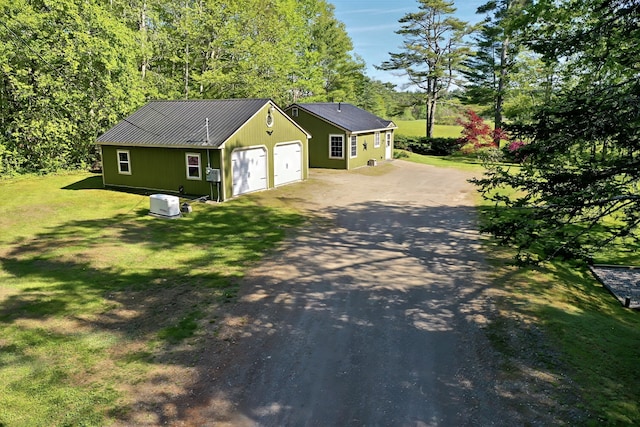 3 Reeds Ln, Belfast, ME 04915 - view of front facade featuring driveway, a garage, a front lawn, and metal roof